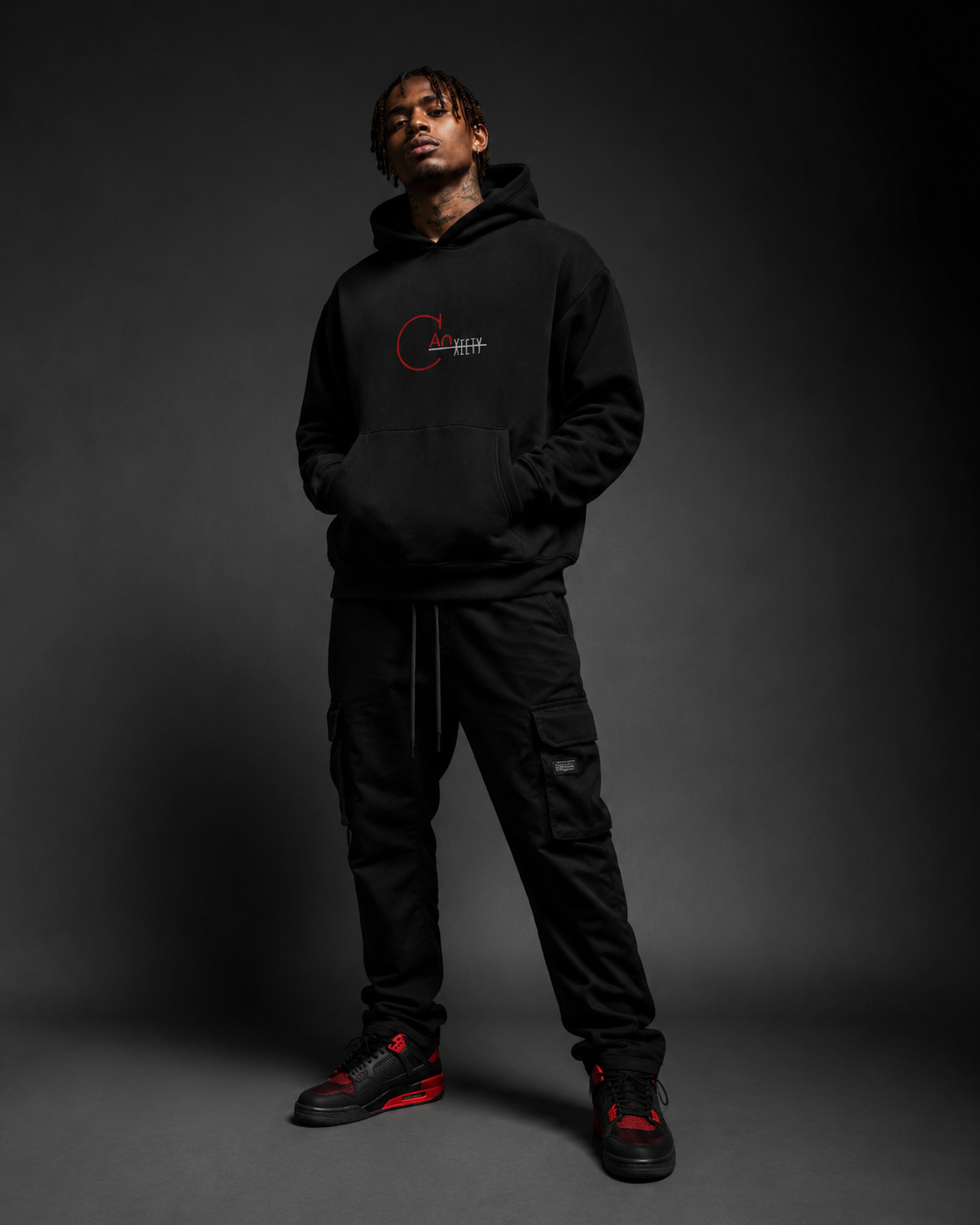 CANxiety model wearing a black heavyweight hoodie in a dark editorial streetwear campaign