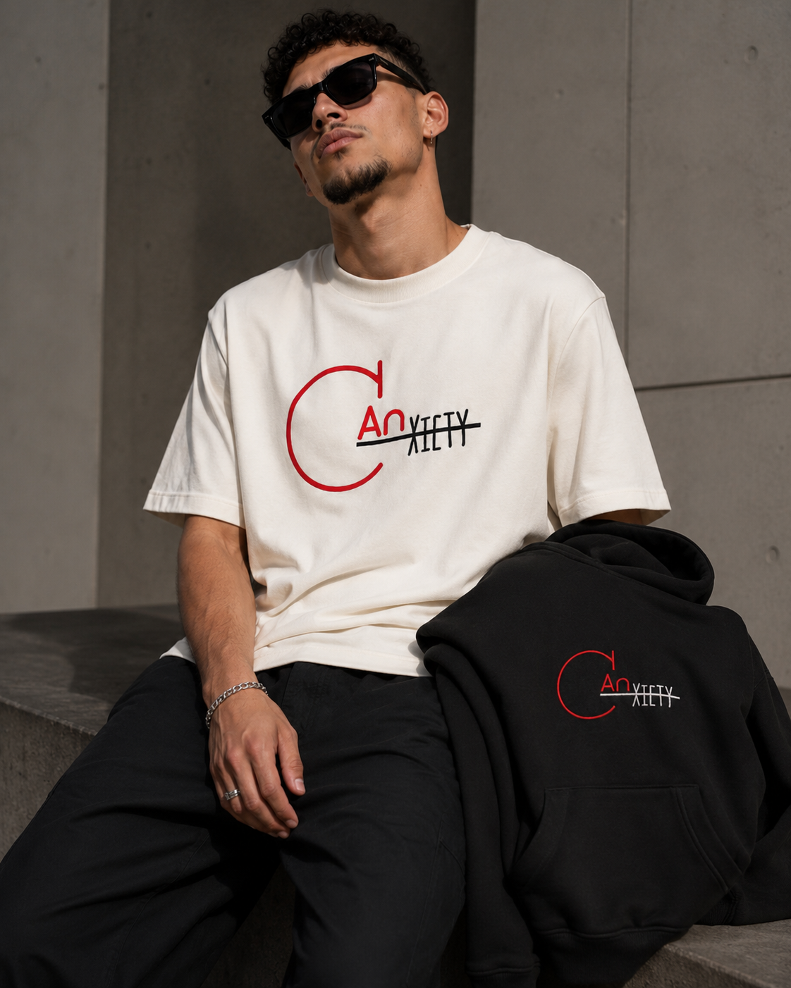 CANxiety First Drop Bundle showing a model with the tee and black hoodie together
