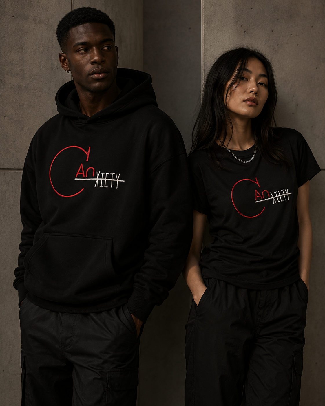 Two CANxiety models wearing black founder drop streetwear against a concrete backdrop